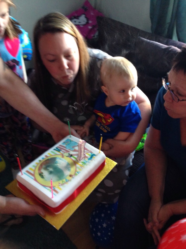 blowing out candles blowing out candles on a first birthday cake